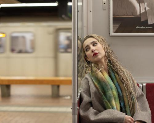 A Girl leaning against subway seat