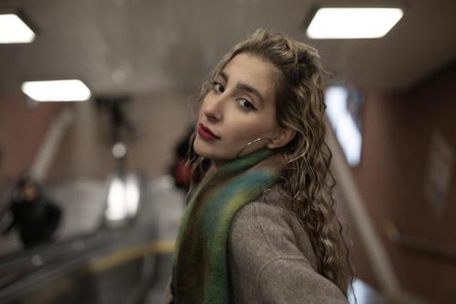 A Girl looking back on elevator in subway